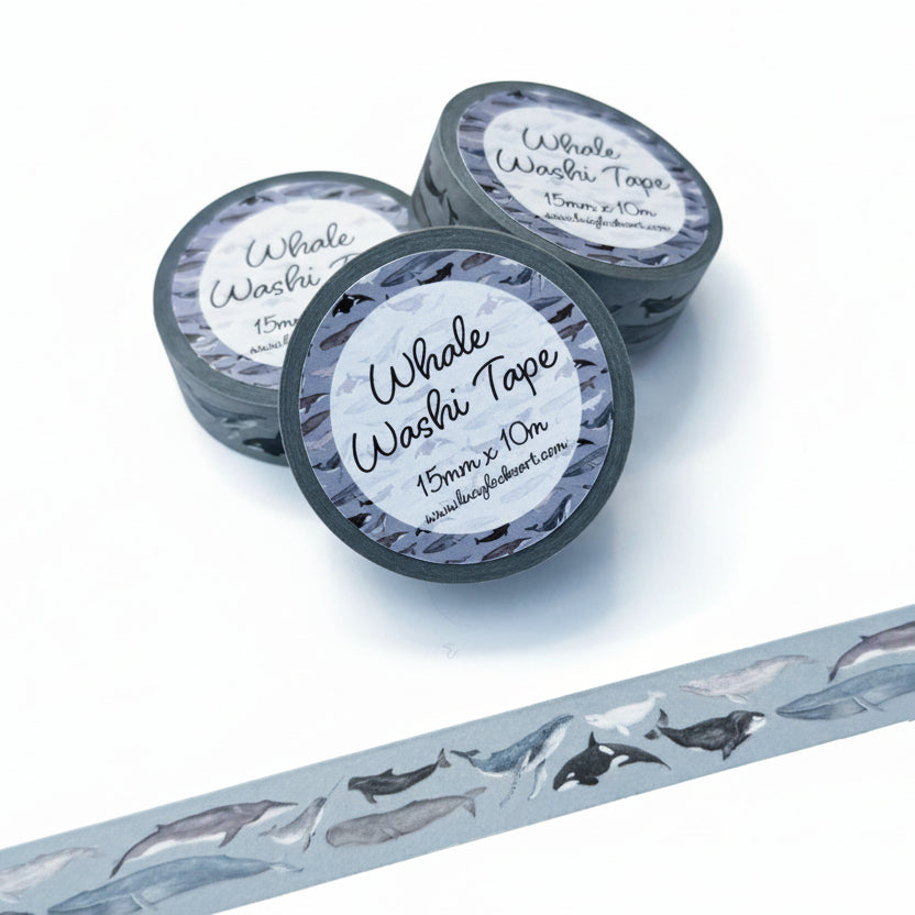 Three rolls of whale-themed washi tape on a light gray background