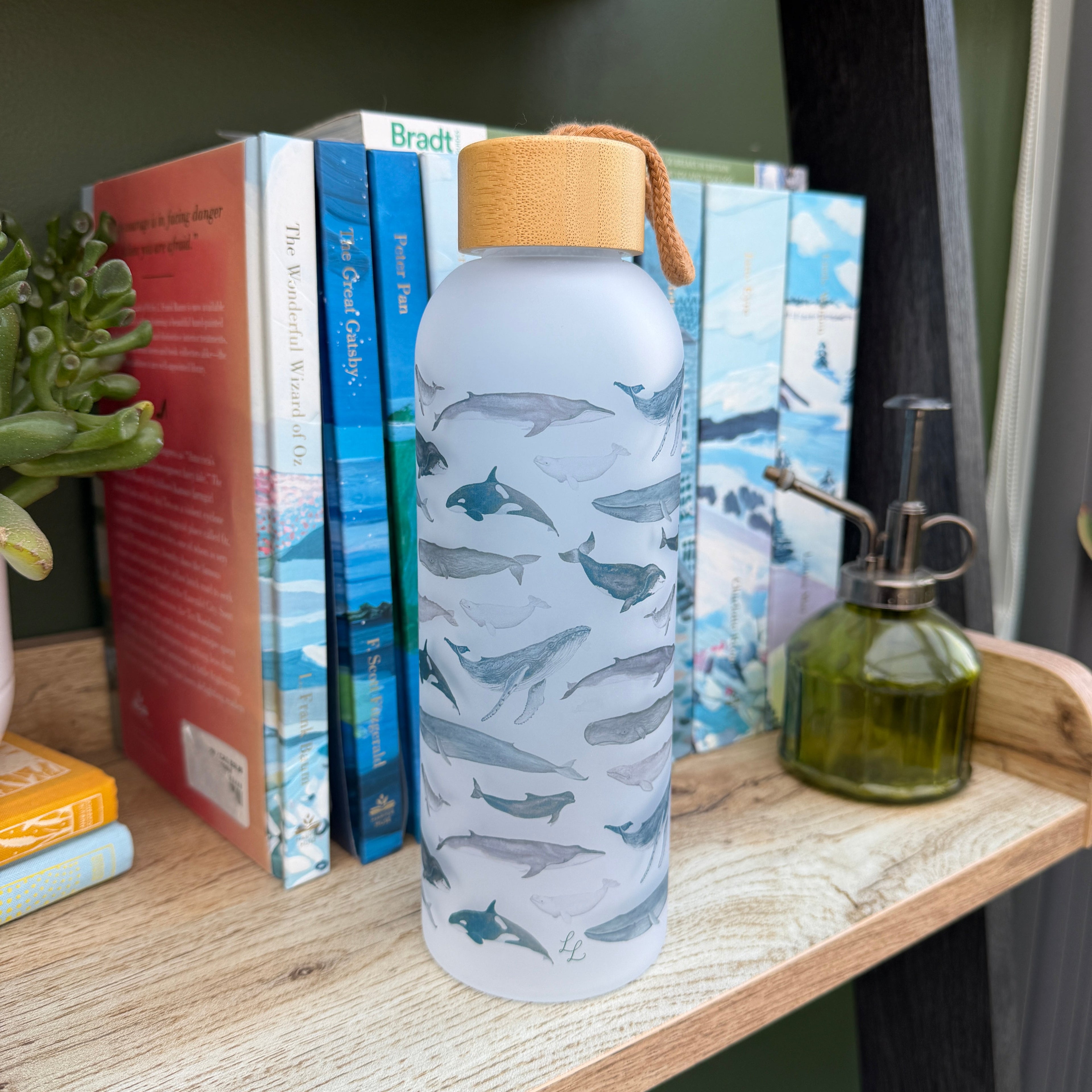 Decorative bottle with a pattern on top of books on a wooden surface